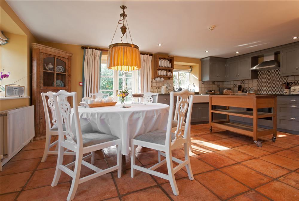 The open-plan kitchen and dining area with french doors leading to the garden at Bookers Cottage, Bruern, near Chipping Norton
