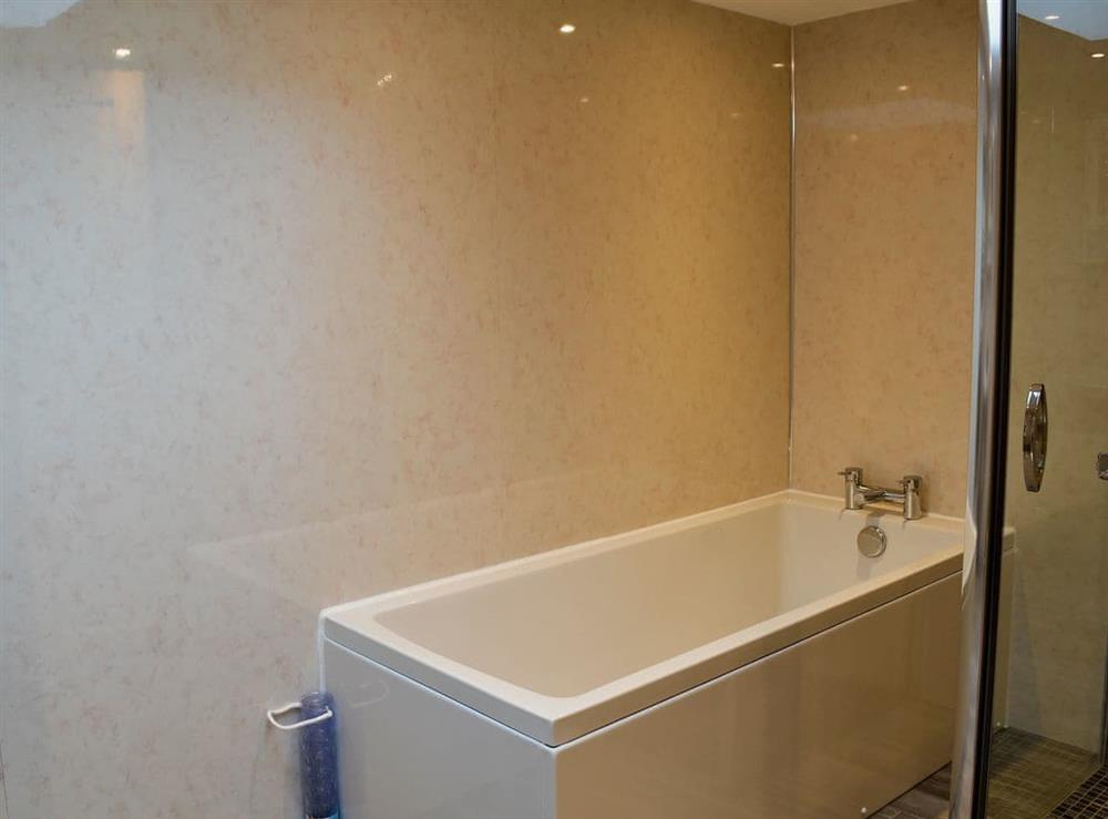 Modern bathroom with bath and shower cubicle at Booth Farm Cottage, 