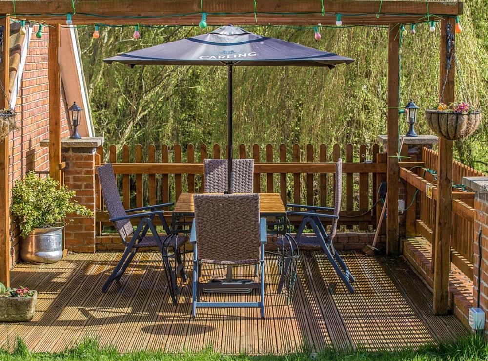 Decked patio area with outdoor furniture at Boothby Cottage in Welton le Marsh, near Spilsby, Lincolnshire