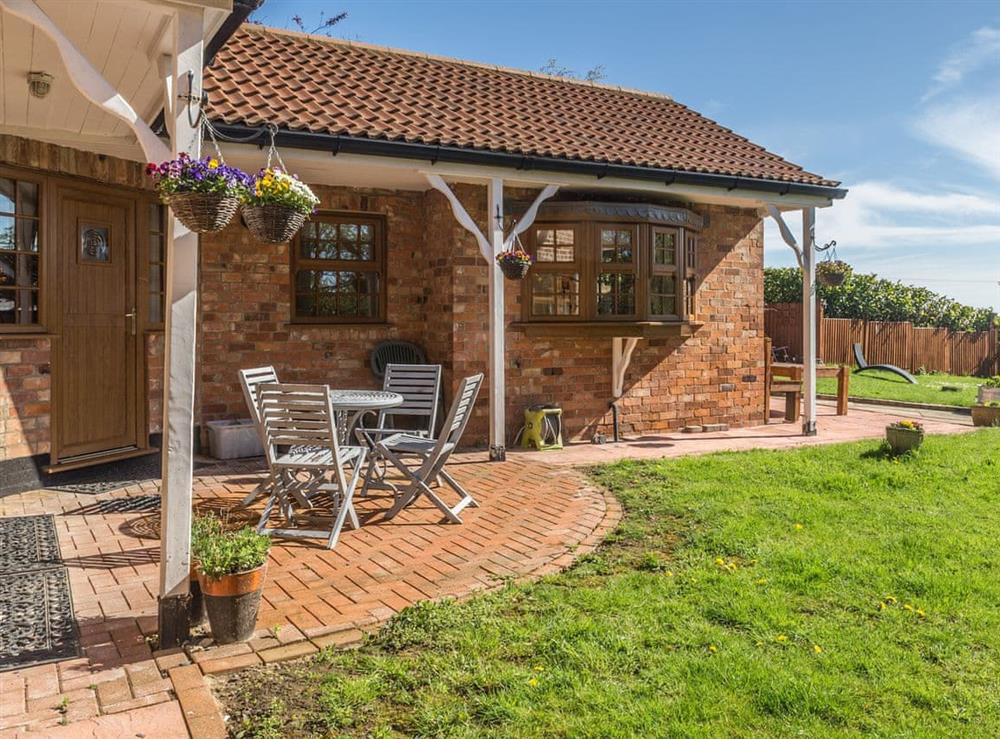 Paved patio area and garden at Boothby Cottage in Welton le Marsh, near Spilsby, Lincolnshire