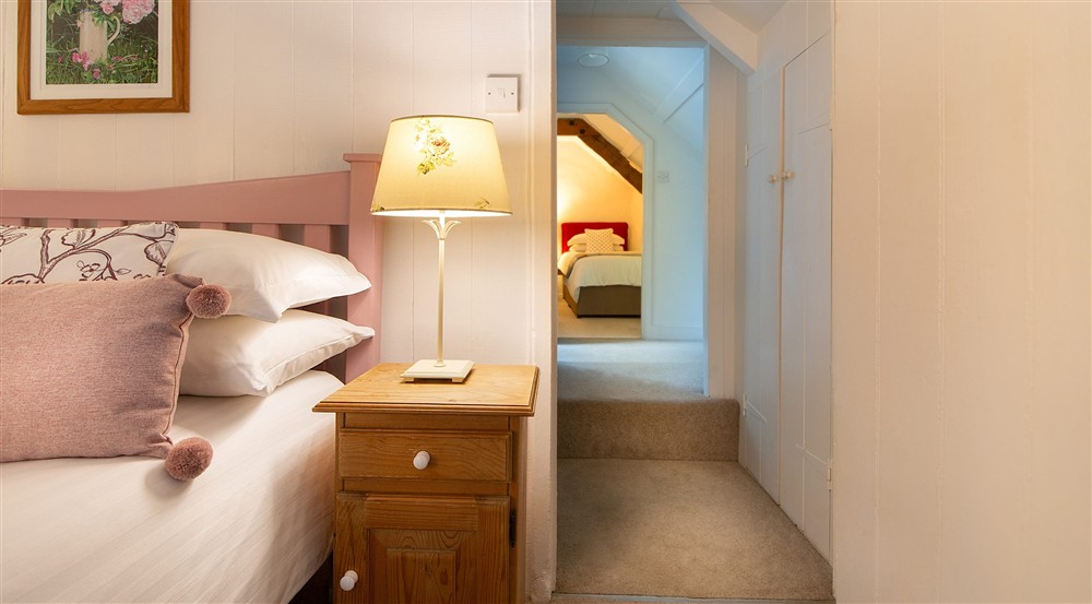 The double bedroom, with the twin bedroom in the background, at Boscastle Elm Cottage in Boscastle, Cornwall