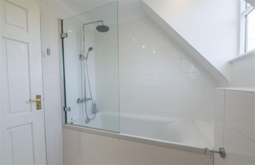 First floor:  Family bathroom with bath with rainfall shower over and separate hand-held attachment (photo 2) at Bosky House, South Creake  near Fakenham
