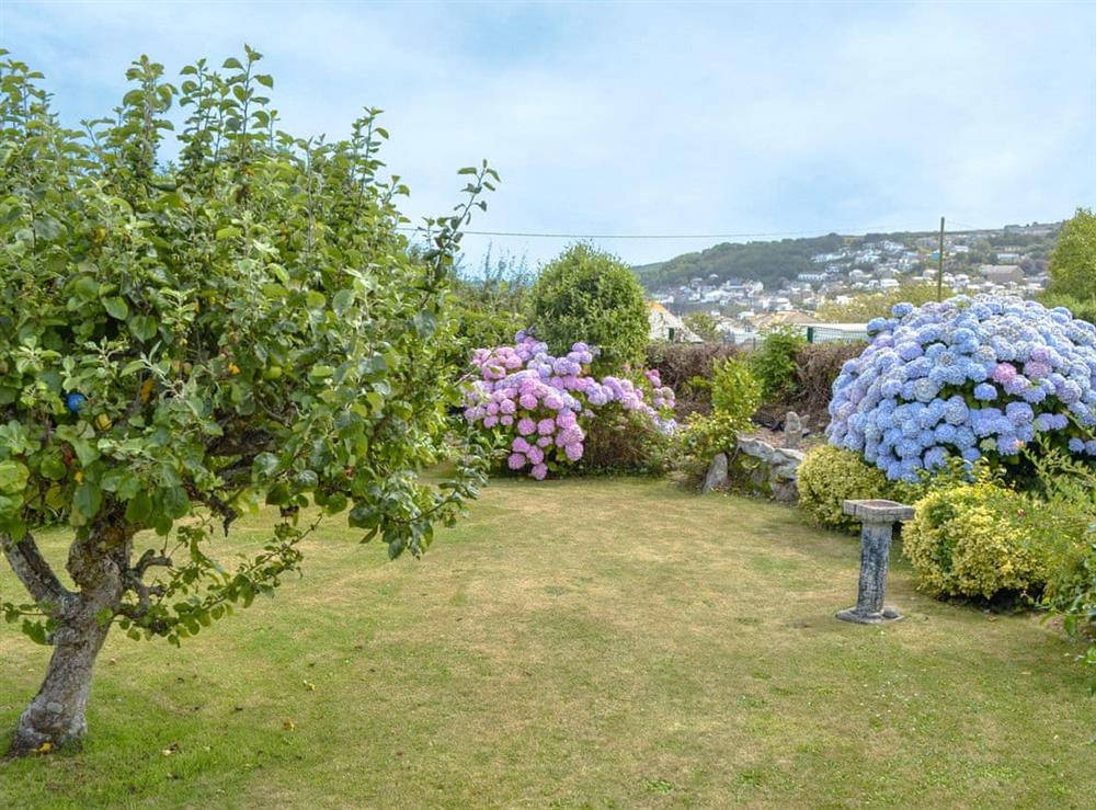 Lawned garden with views towards the pretty village of Newlyn at Bosorne in Penzance, Cornwall
