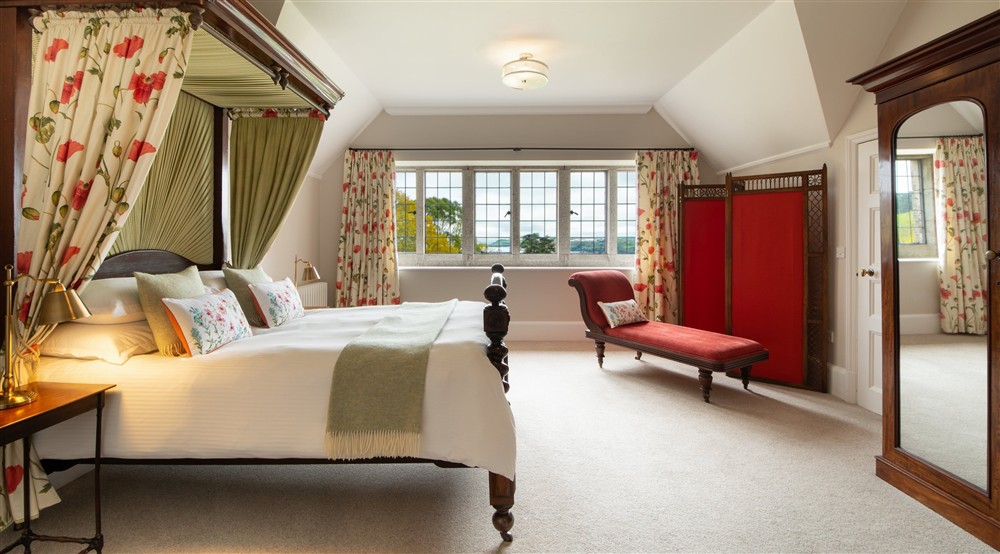 The four-poster bedroom at Bosveal in Falmouth, Cornwall
