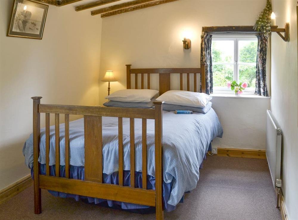 Airy twin bedroom at Boundstone Farmhouse in Littleham, near Bideford, Devon