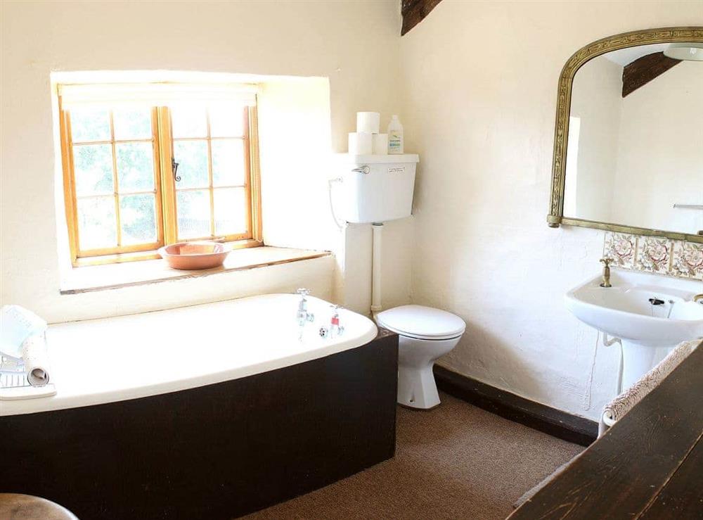 One of three, this traditional bathroom has views out over the stunning Devon countryside at Boundstone Farmhouse in Littleham, near Bideford, Devon