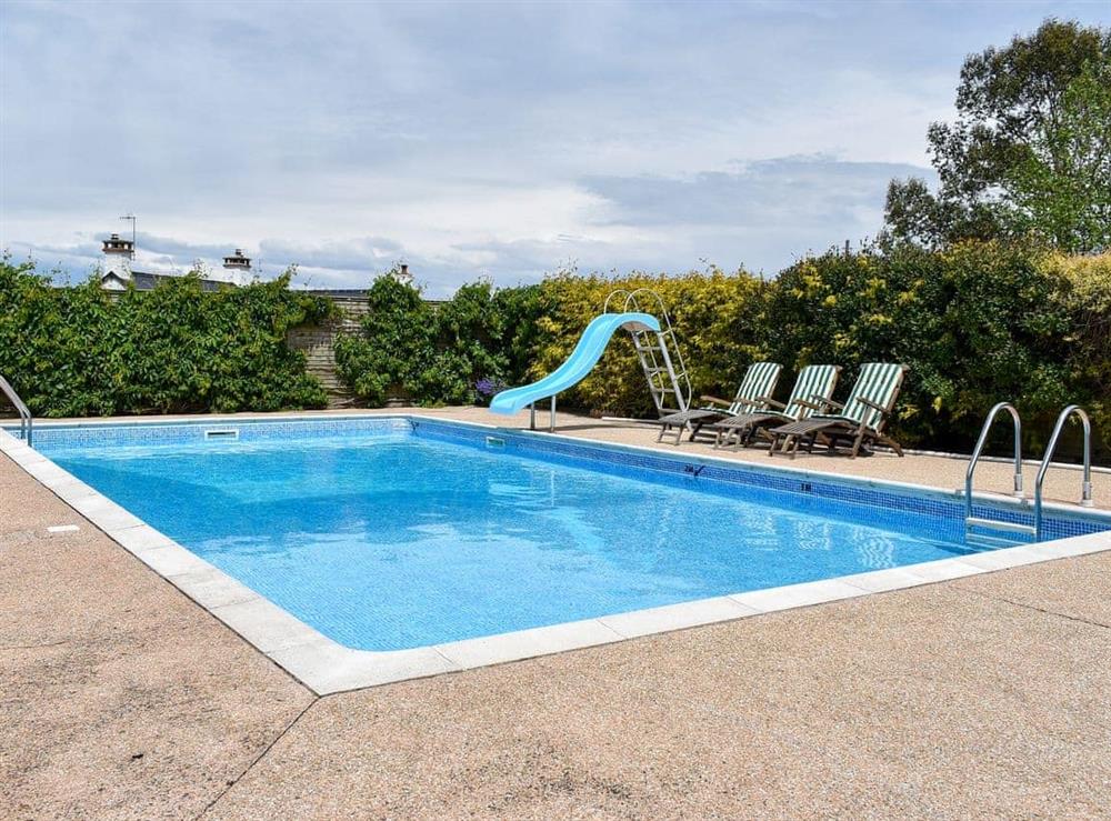 Heated outdoor swimming pool at Bournstream Cottage in Bilbrook, near Minehead, Somerset