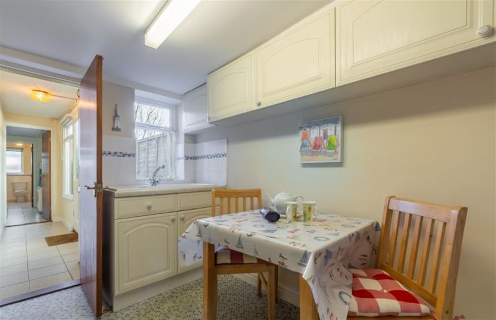 Kitchen with breakfast table and seating for two at Bovis Cottage, Southwold