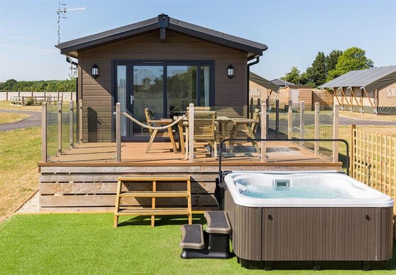 Outside the Walnut, with a hot tub at Bowbrook Lodges in Pershore, Worcestershire