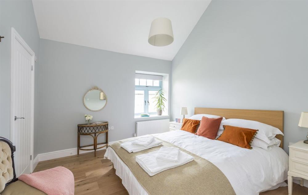 Bedroom two with a king-size bed and en-suite shower room at Bower Cottage, Hooke