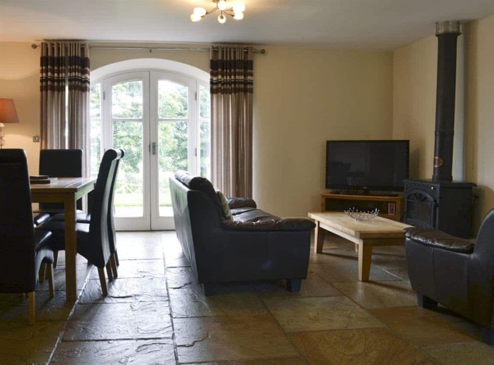 Comfortable lounge with wood burner and Freeview TV at Raby Cottage, 
