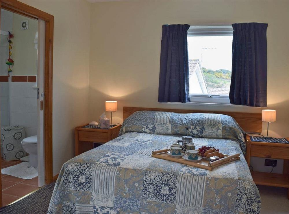 Elegantly decorated double bedroom with en-suite shower room at Bracelet Cottage in Mumbles, near Swansea, Glamorgan, West Glamorgan