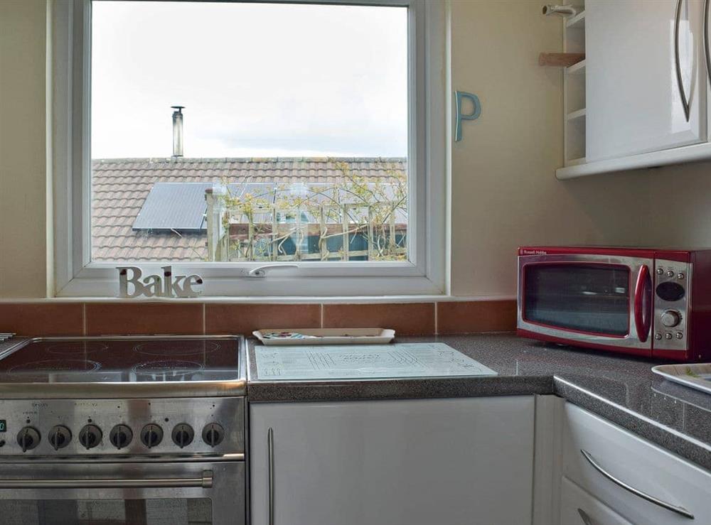 Galley style kitchen at Bracelet Cottage in Mumbles, near Swansea, Glamorgan, West Glamorgan