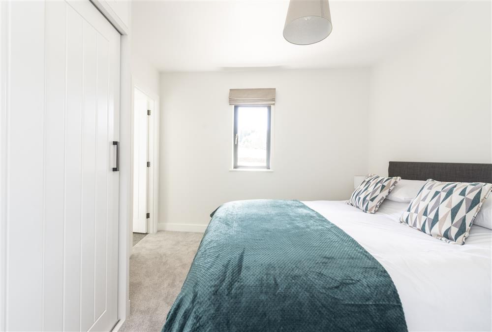 Bedroom two with a 5ft king-size bed and en-suite shower room at Bracken, Ansty, Dorchester