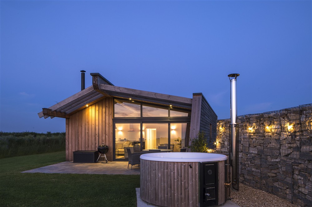 The wood burning hot tub sits next to the dining terrace at Bracken, Ansty, Dorchester