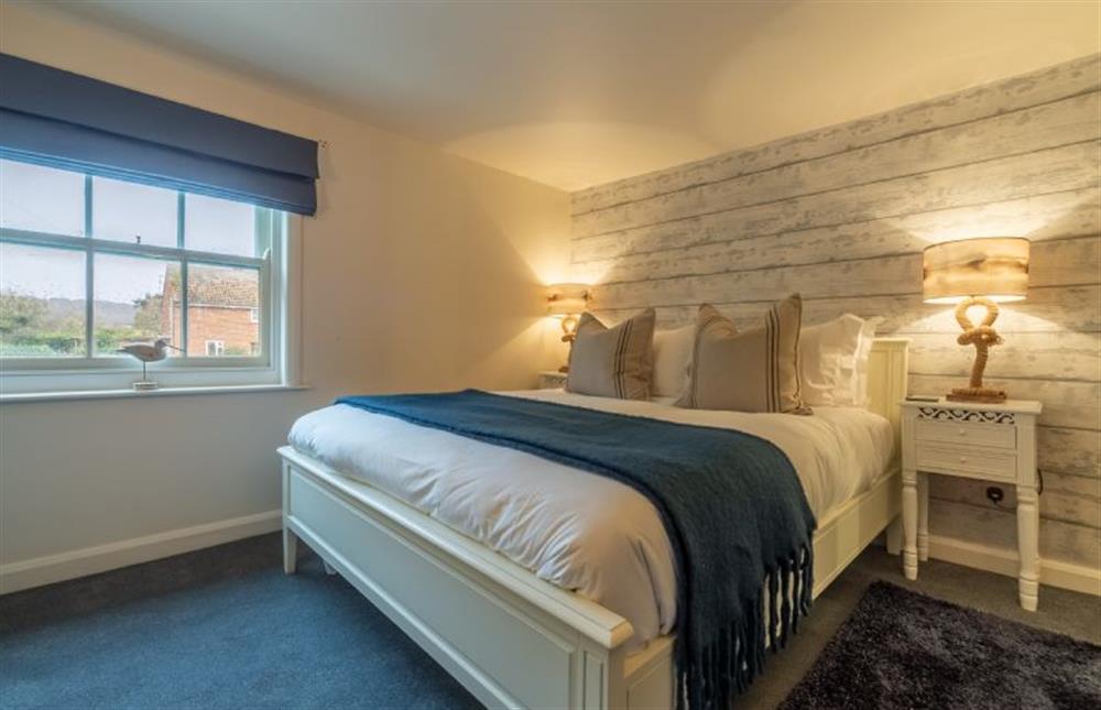 First floor: Master bedroom with King-size bed at Bracken Cottage, Brancaster Staithe near Kings Lynn