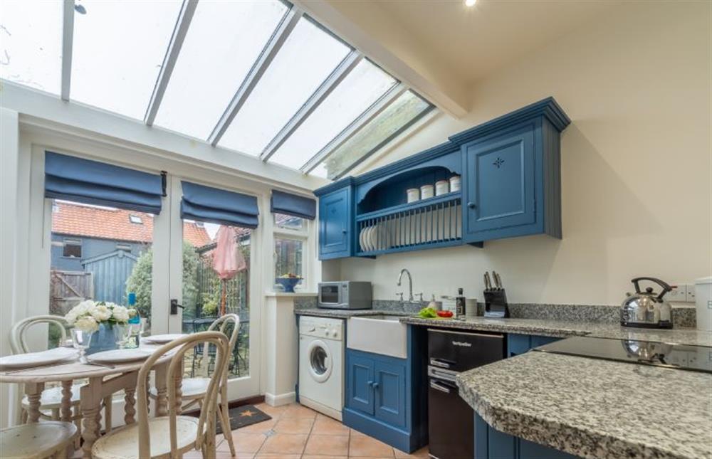 Ground floor: Kitchen with glass roof and french doors leading to the pretty paved garden. at Bracken Cottage, Brancaster Staithe near Kings Lynn