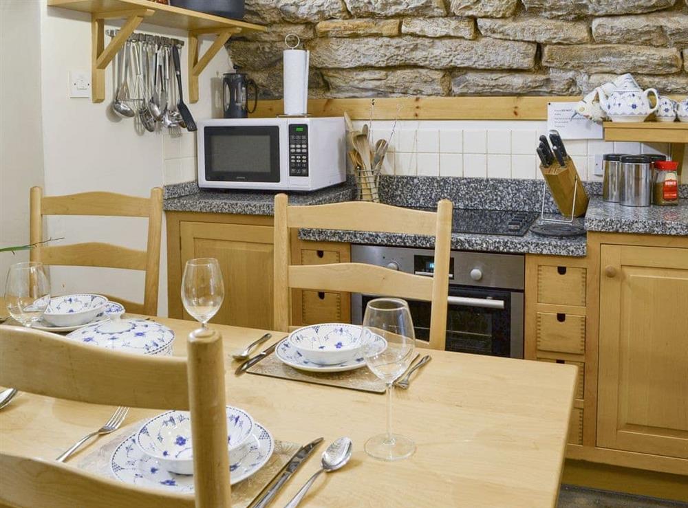 Fully equipped kitchen with dining area at Braidwood Castle, 
