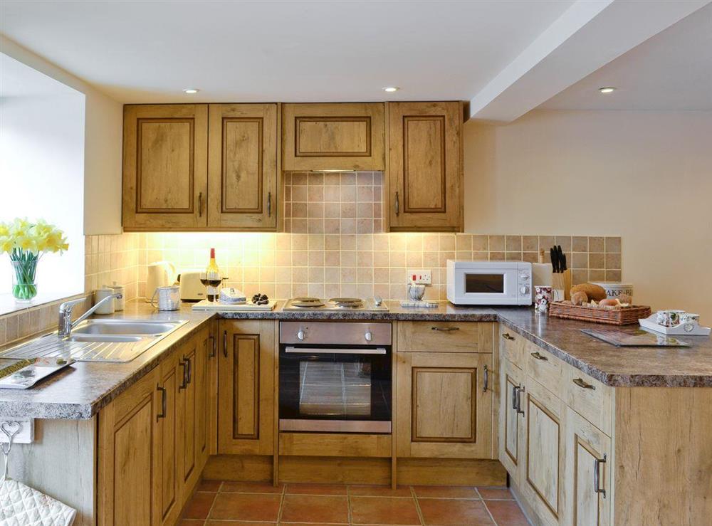 Well-equipped fitted kitchen at Honey Cottage, 