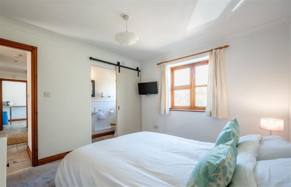 Ground floor: Master bedroom with en-suite shower room at Brambles, Brancaster Staithe near Kings Lynn