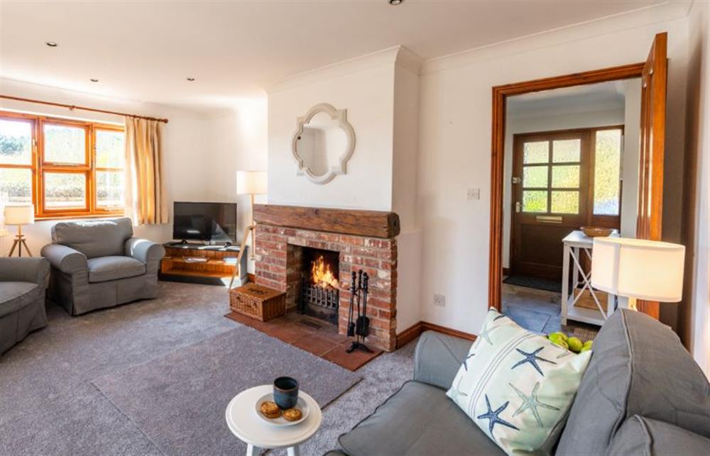Ground floor: Sitting room with open fire .... at Brambles, Brancaster Staithe near Kings Lynn