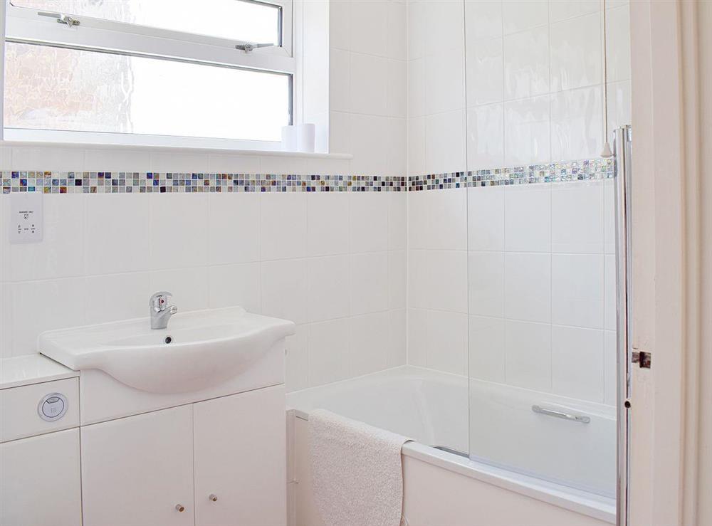 Beautifully tiled bathroom with shower over bath at Brambles Cottage in Freshwater, Isle of Wight
