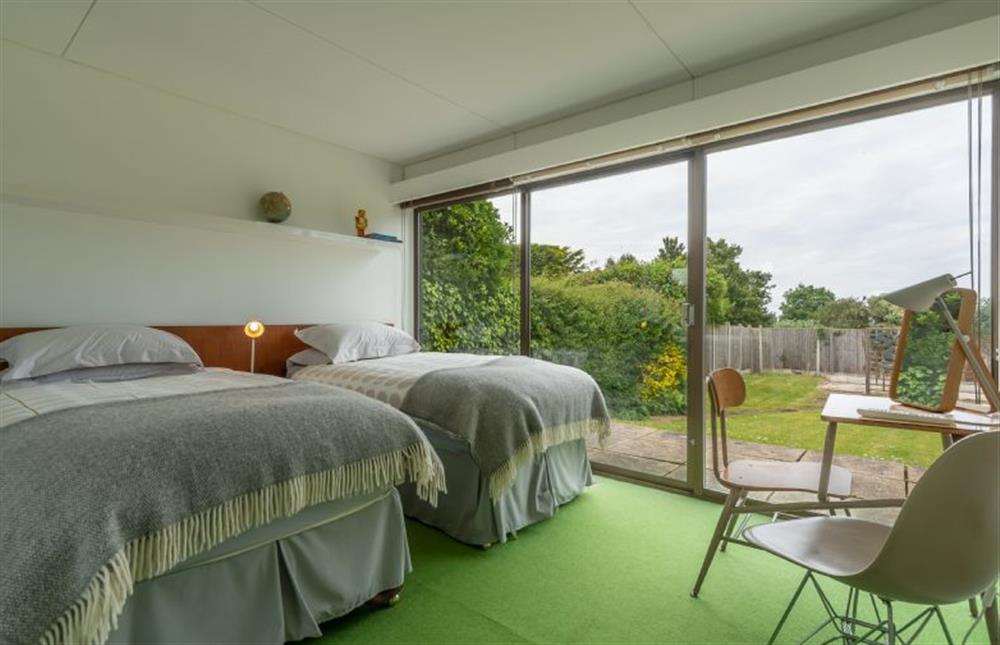 Bedroom two: with full-size twin beds and sliding doors to rear patio and garden at Bramley, Old Hunstanton