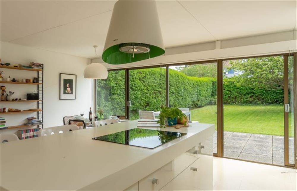 Kitchen area: with central island and sliding doors to front patio and garden at Bramley, Old Hunstanton