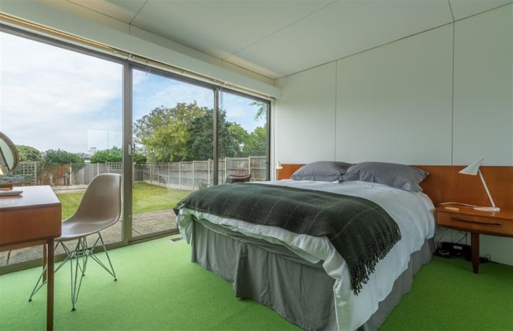 Master bedroom: with king-size bed and sliding doors to rear patio and garden at Bramley, Old Hunstanton