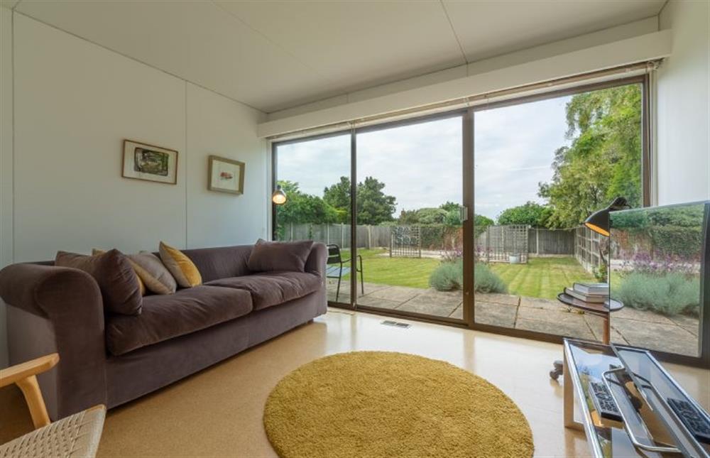 Sitting room: with comfy sofa and sliding doors to rear patio and garden at Bramley, Old Hunstanton