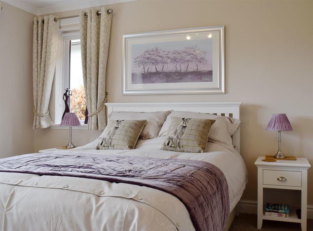 Comfortable bedroom with king sized bed at Brandelhow in Keswick, Cumbria