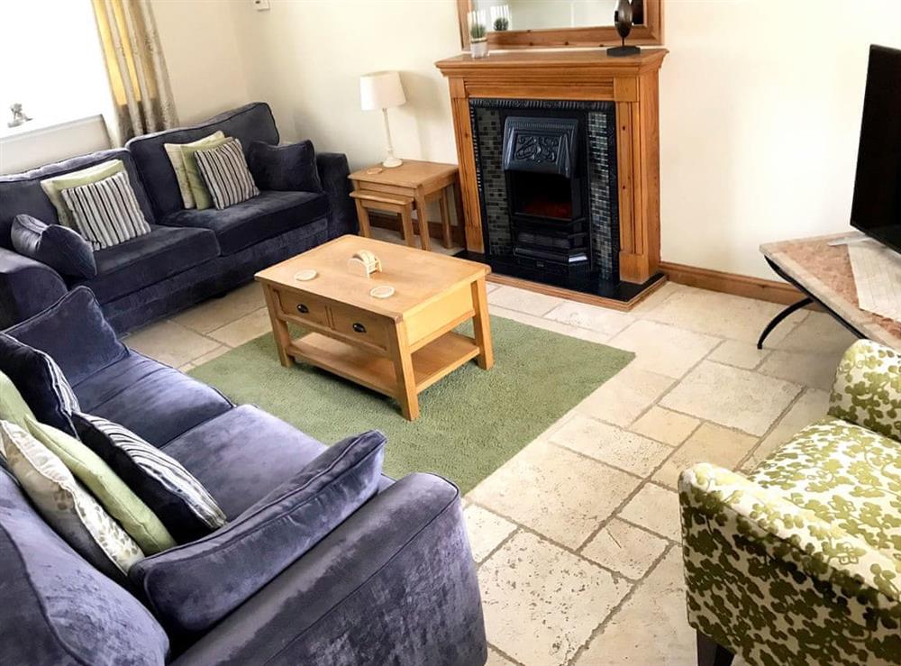 Comfortable living room with tiled floor at Brankley Cottage in Burton-On-Trent, Staffordshire