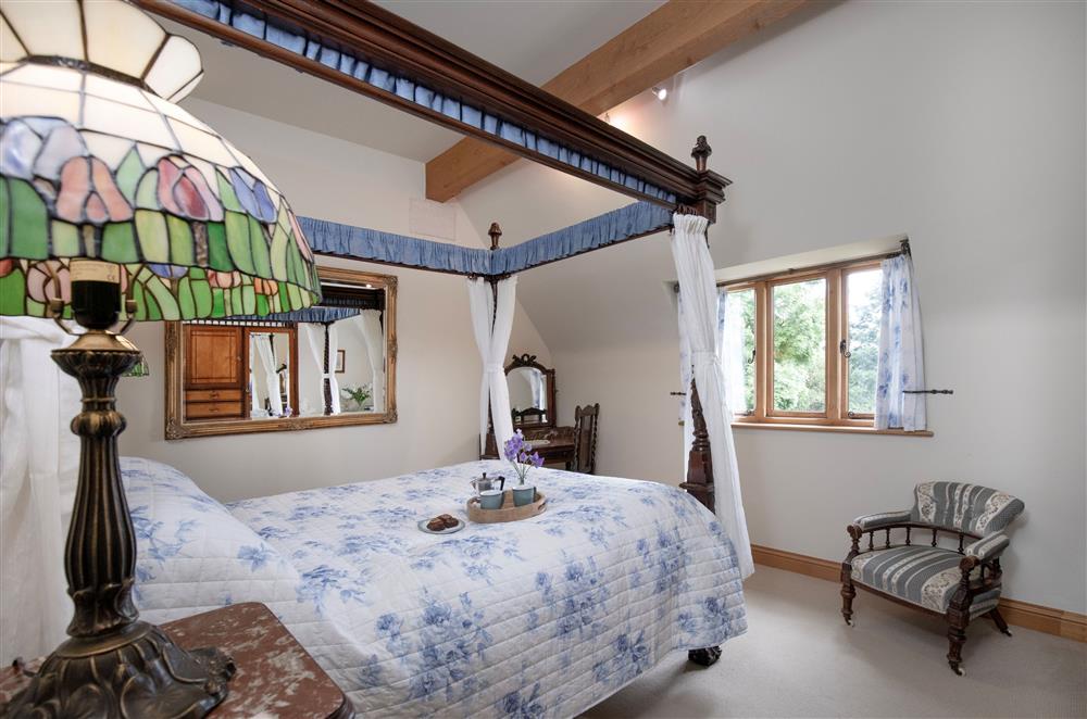 The beautiful four-poster bed, with luxurious bedding