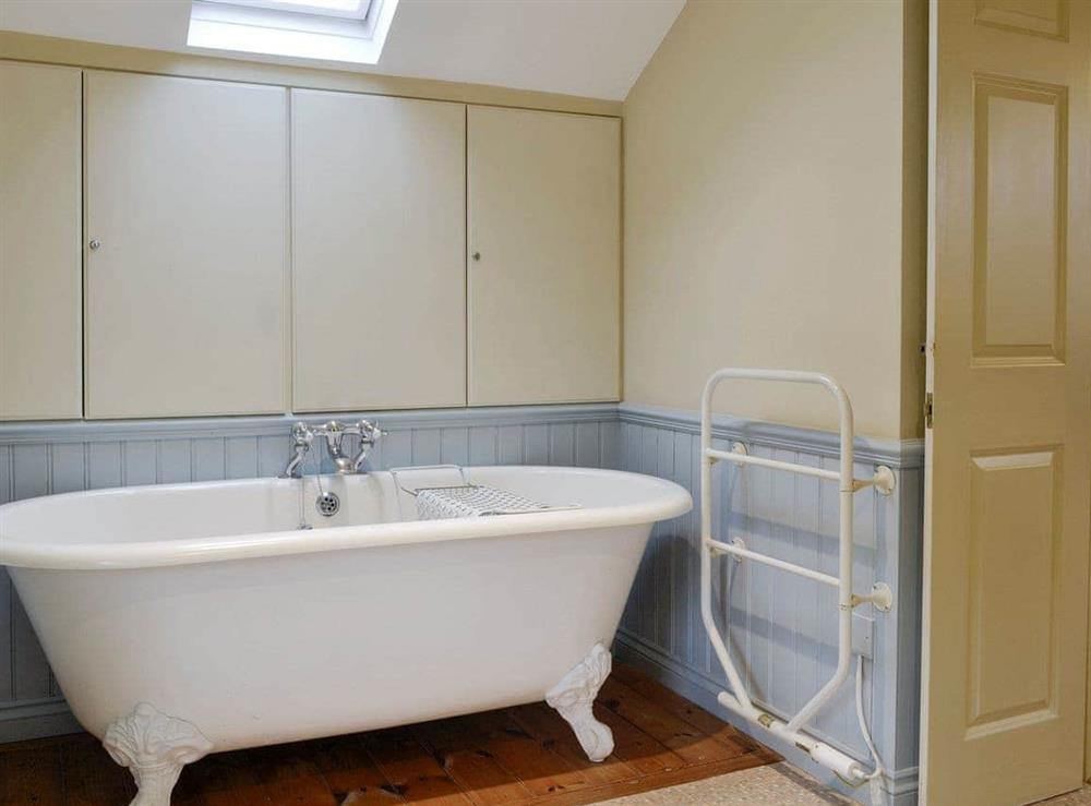En-suite bathroom with free-standing bath and shower cubicle at Brasscam in Keswick, Cumbria