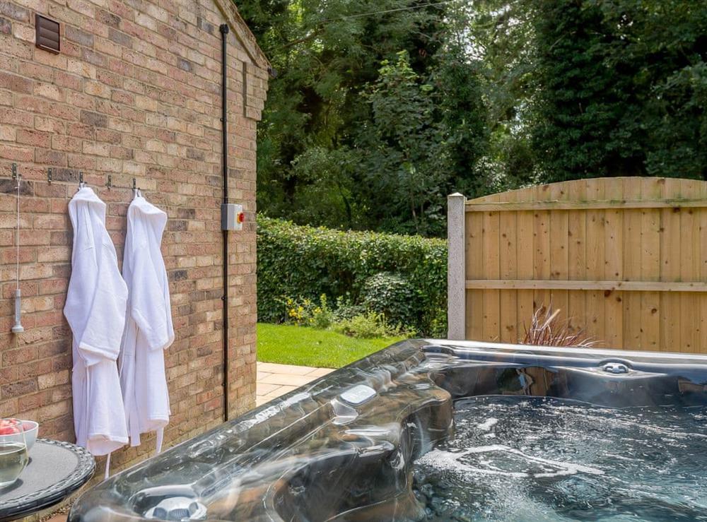 Attractive hot tub area at Woodcutters Cottage, 