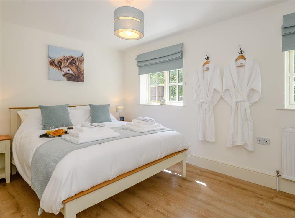 Relaxing bedroom with king sized bed at Woodcutters Cottage, 
