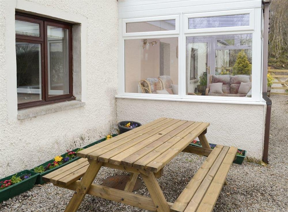 Gravelled patio area with outdoor seating at Breacwell Cottage in Migdale, near Dornoch, Northern Highlands, Ross-Shire