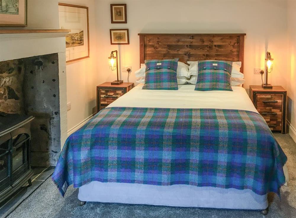 This room is on the ground floor and features a King size double bed. The original bread oven is located in the wall next to the fireplace at Bread Oven Cottage in Smailholm, near Kelso, Roxburghshire