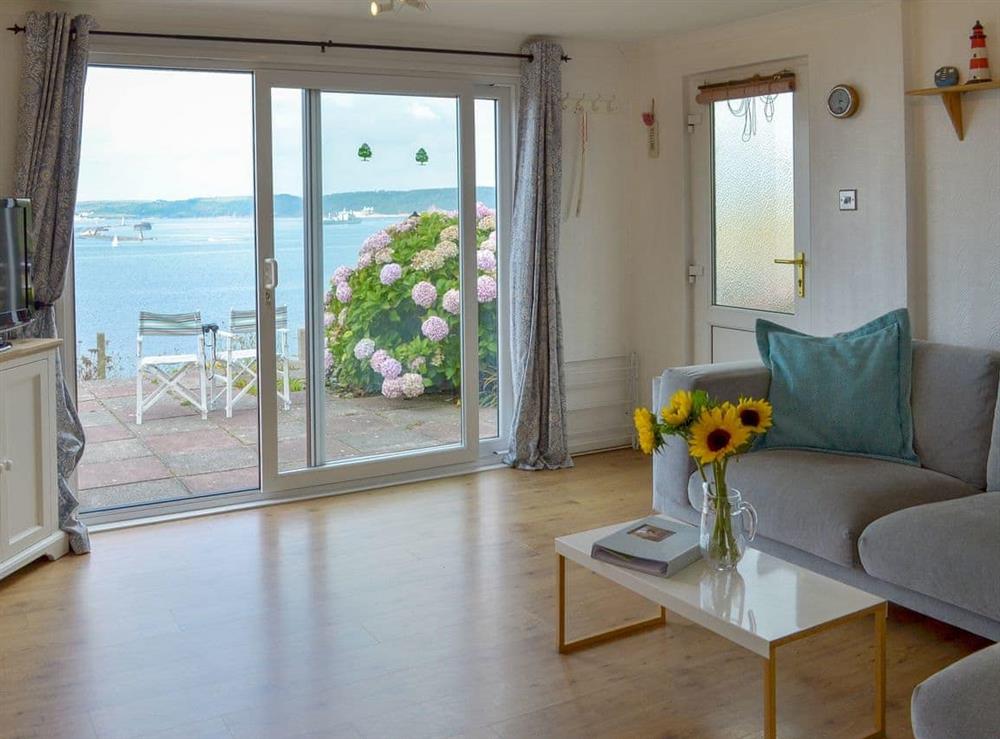 Living/ dining room that looks directly across the bay at Breakwater View in Down Thomas, near Plymouth, Devon