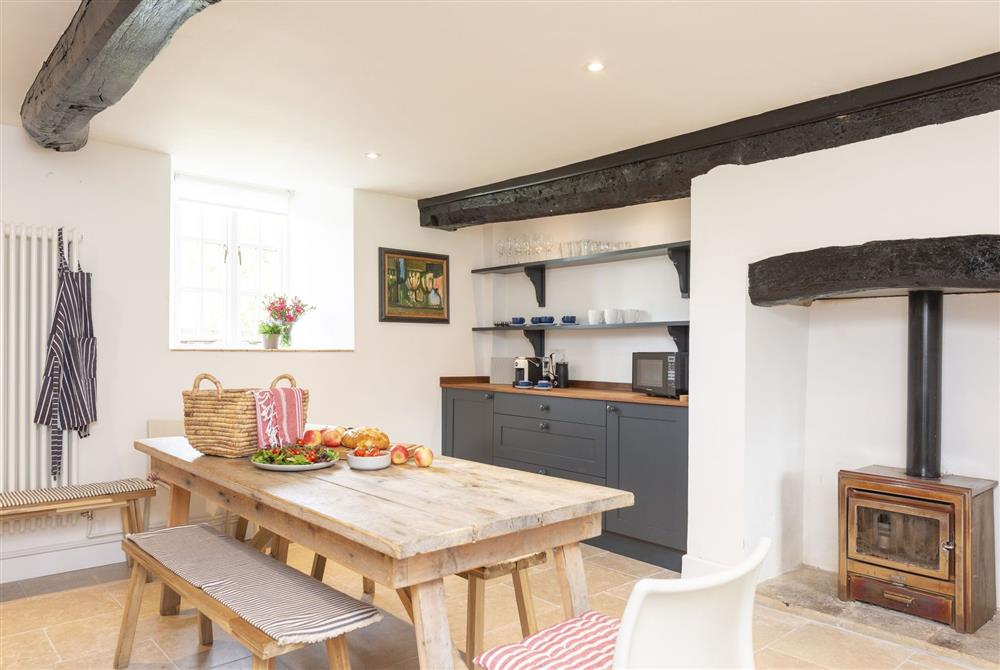 Dining area with benches and chairs for up to 10 guests at Brew House Cottage, Clifton Maybank, nr Sherborne