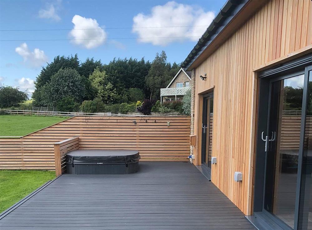 Decked area with sunken hot tub at Brewers Cottage in Near Hexham, Northumberland