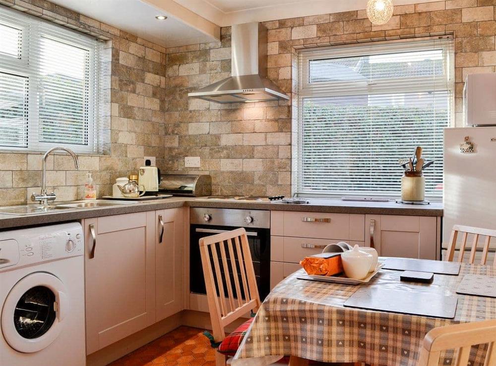 Beautifully tiled kitchen with dining area at Briar Bank Cottage in Cockermouth, Cumbria