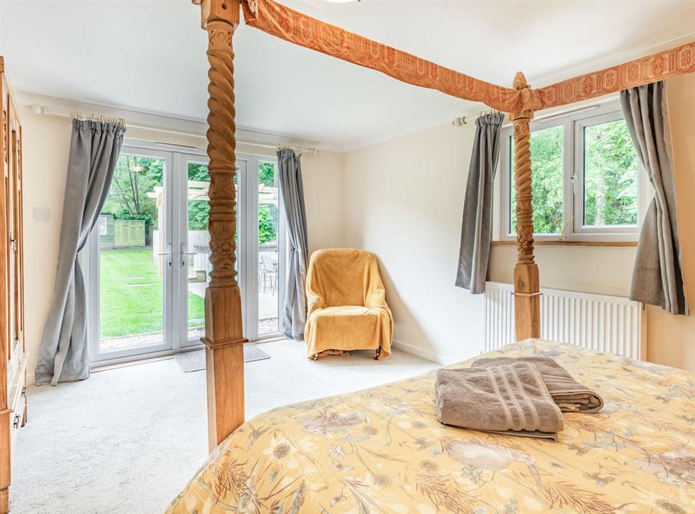 Light and airy ground floor four poster bedroom at Brick Cottage in Bawsey, near King’s Lynn, Norfolk