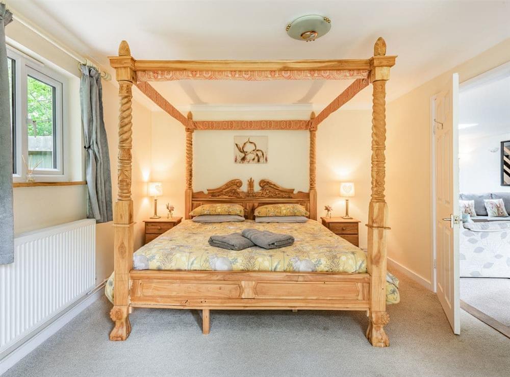 Relaxing ground floor four poster bedroom at Brick Cottage in Bawsey, near King’s Lynn, Norfolk