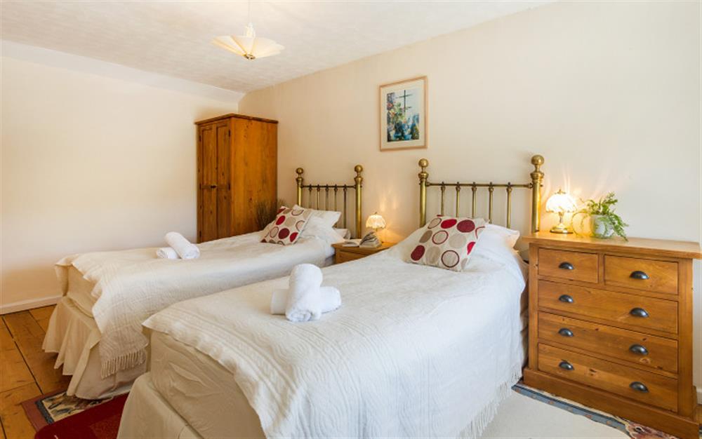 Bedroom 2 with twin 3ft beds, wardrobe and drawers at Bridge Cottage in Powerstock