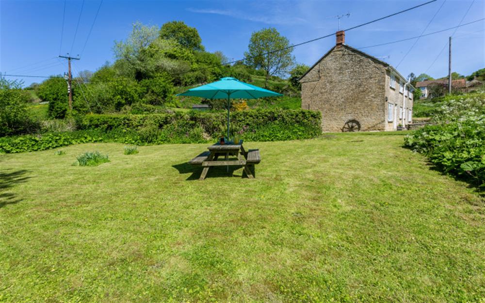 Large grassed area to the side of the property at Bridge Cottage in Powerstock