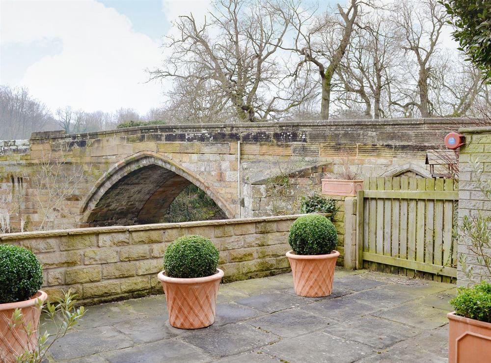 Patio area overlooking the river at Bridge House in Helmsley, N. Yorkshire., North Yorkshire