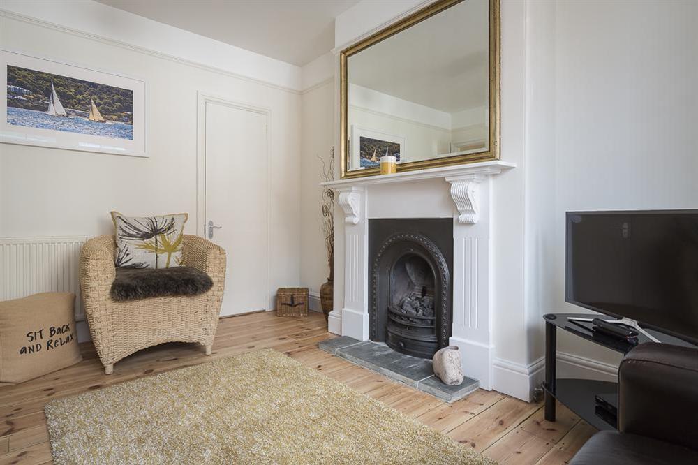 Sitting room with feature fireplace and wooden flooring
