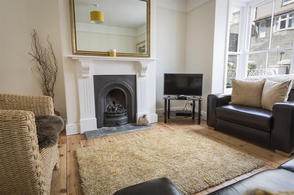 Sitting room with feature fireplace and wooden flooring