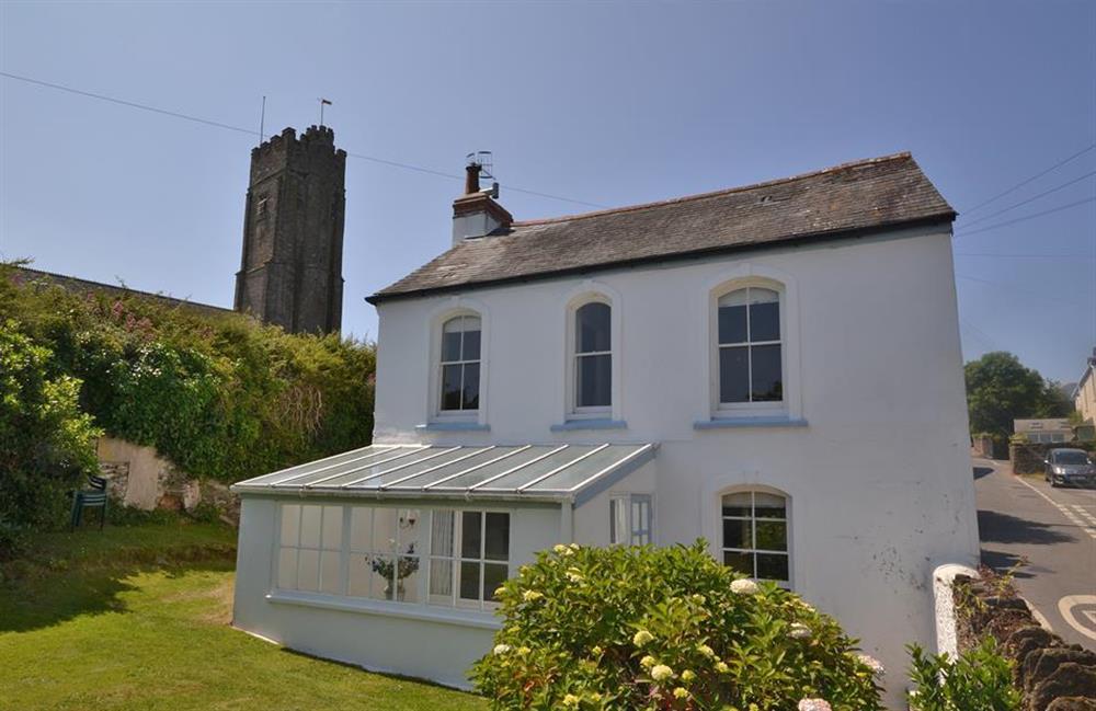 View of exterior with nearby church tower at Britannia Cottage, Stoke Fleming